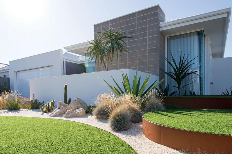 Modern front yard landscaping with decorative gravel and green lawn